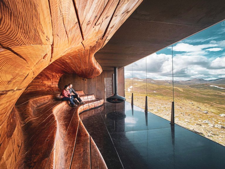 A couple sitting in a scenic cabin.