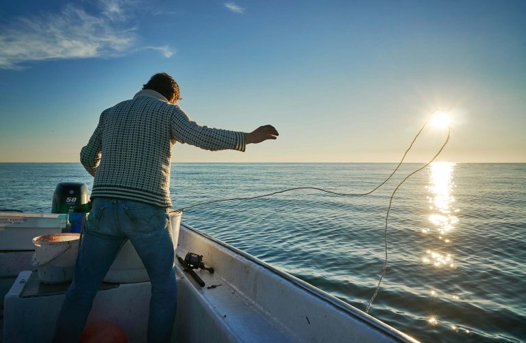 Man fishing in the ocean.