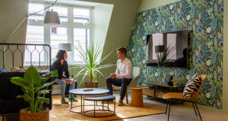 Two persons sitting in the Item office.