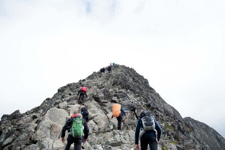 Hikers near a rocky mountain peak.